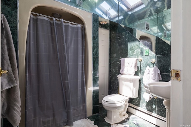 bathroom with a skylight, a shower with curtain, tile walls, and toilet