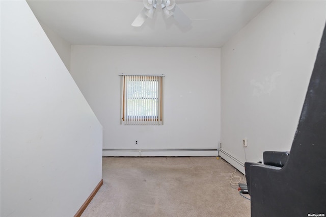 empty room with ceiling fan, light carpet, and a baseboard heating unit