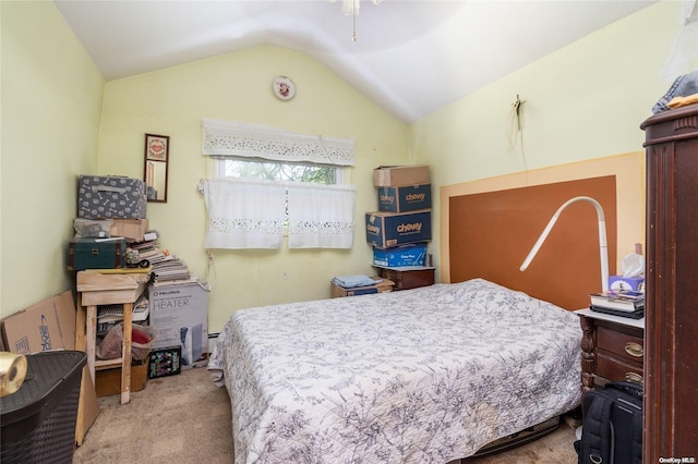 bedroom with light carpet and vaulted ceiling