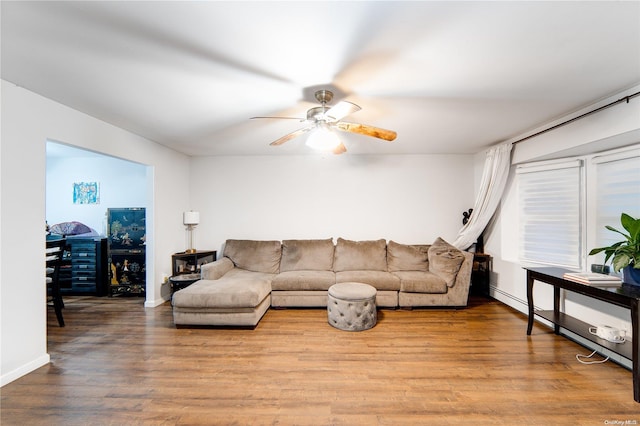 living room featuring ceiling fan and light wood-type flooring