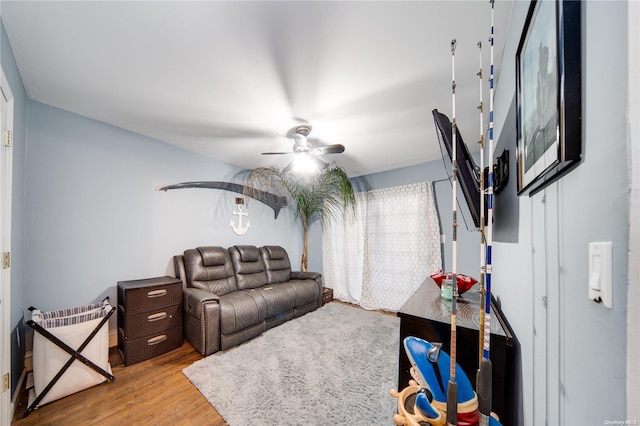 living room with hardwood / wood-style flooring and ceiling fan