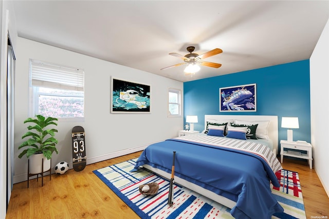 bedroom with wood-type flooring and ceiling fan