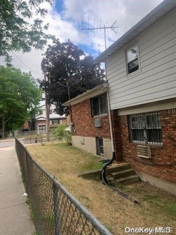 view of side of home featuring a yard