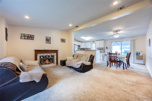 49 Concord Rd, Shirley, NY 11967 - living room featuring light carpet, a fireplace, recessed lighting, and ceiling fan