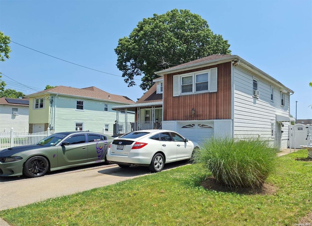 view of front of property with a garage and a front lawn