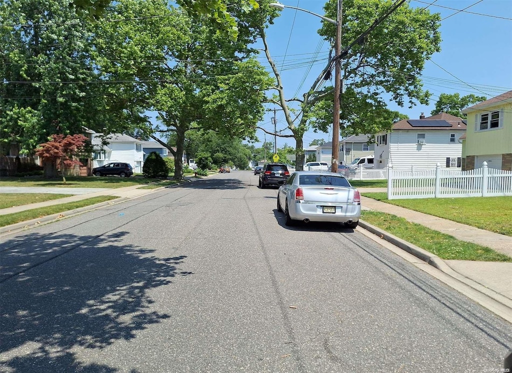 102 Hausch Blvd, Roosevelt, NY 11575 - view of asphalt street with sidewalks, curbs, and a residential view