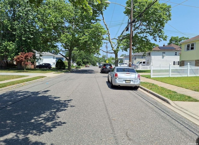 102 Hausch Blvd, Roosevelt, NY 11575 - view of asphalt street with sidewalks, curbs, and a residential view