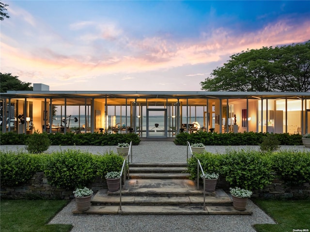 view of back house at dusk