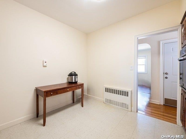 interior space with light hardwood / wood-style flooring and radiator