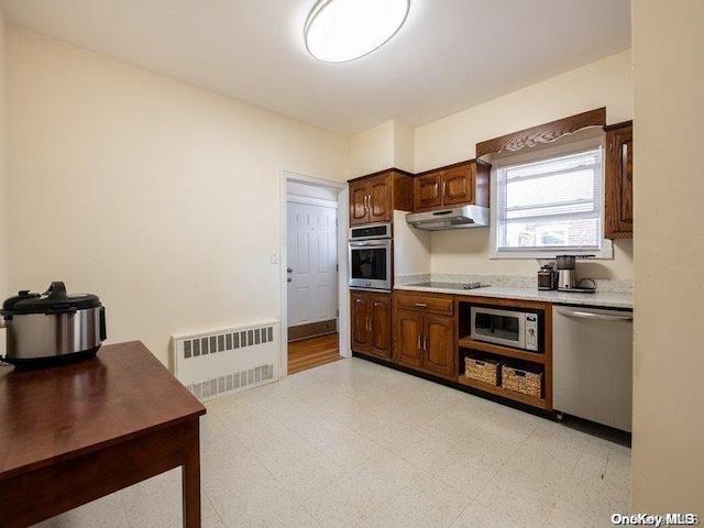 kitchen with radiator heating unit, dark brown cabinets, and appliances with stainless steel finishes