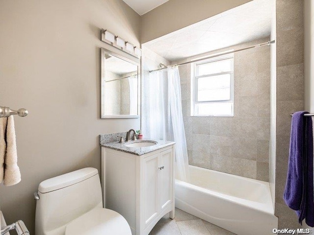 full bathroom featuring toilet, vanity, tile patterned floors, and shower / bath combo with shower curtain