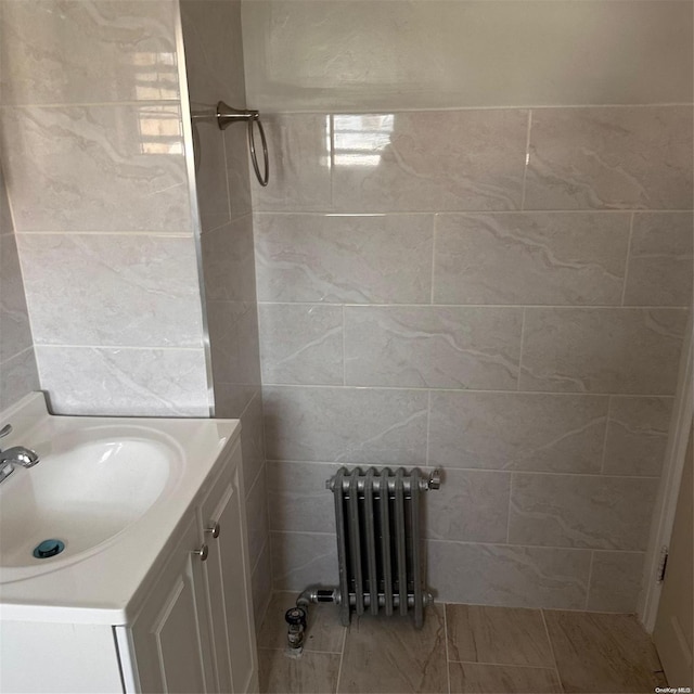 bathroom featuring radiator heating unit and vanity