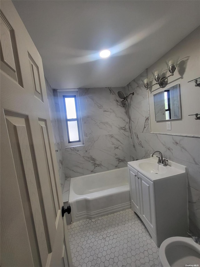 bathroom with vanity, tile patterned floors, tiled shower / bath, tile walls, and a notable chandelier