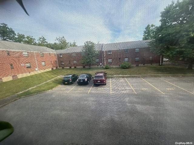 view of car parking featuring a lawn