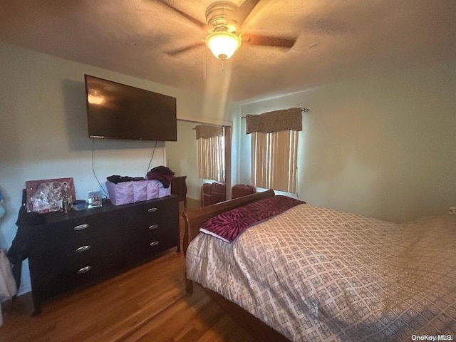 bedroom with wood-type flooring and ceiling fan