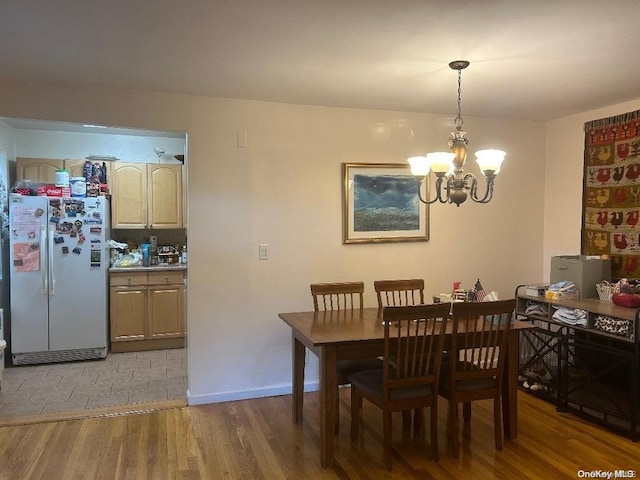 dining space with a chandelier and hardwood / wood-style flooring