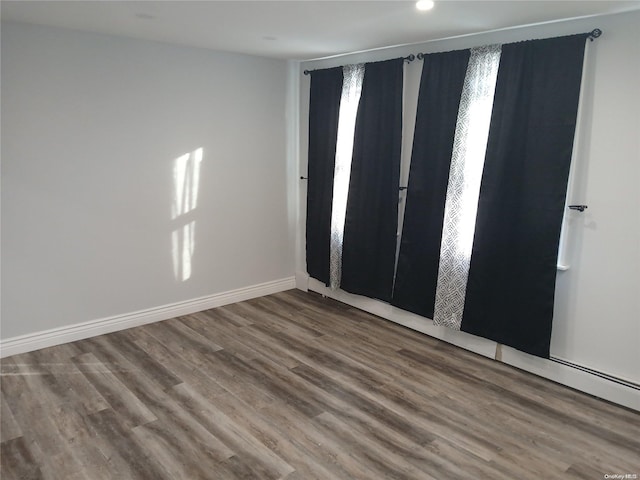 unfurnished room with hardwood / wood-style floors and plenty of natural light