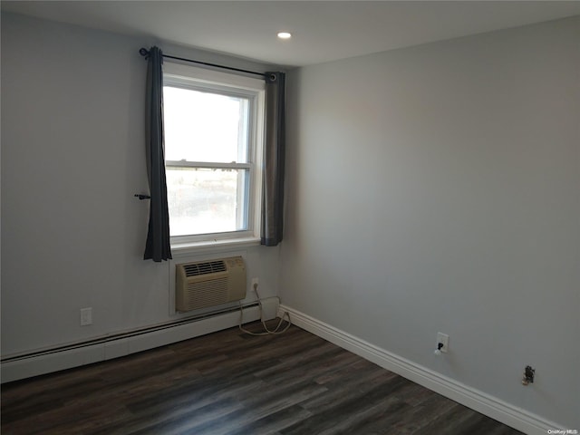 unfurnished room with a wall mounted air conditioner, dark hardwood / wood-style floors, and a baseboard radiator