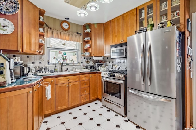 kitchen with sink, appliances with stainless steel finishes, and tasteful backsplash