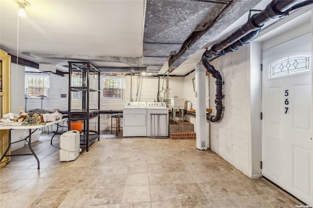 basement with sink and washer and dryer