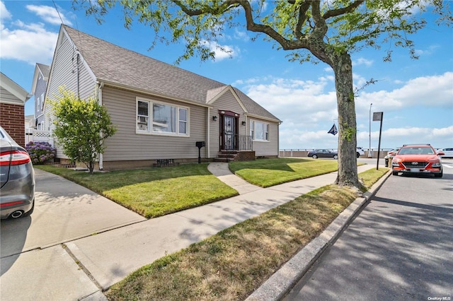 bungalow-style home with a front lawn