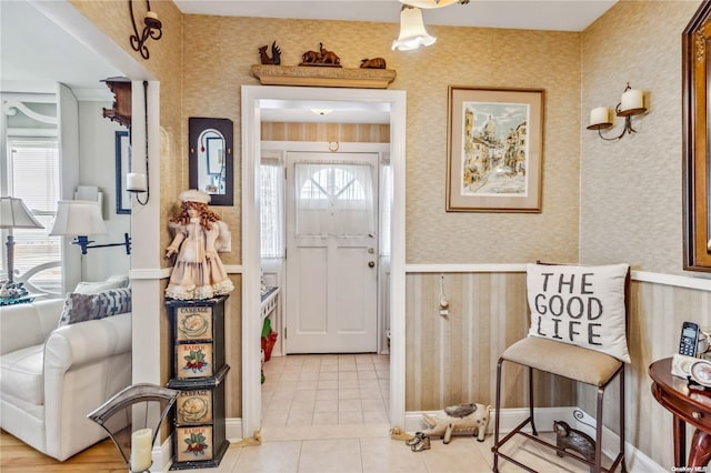 foyer entrance with light tile patterned floors and a healthy amount of sunlight