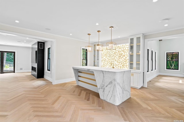 interior space with light parquet flooring, ornamental molding, and sink