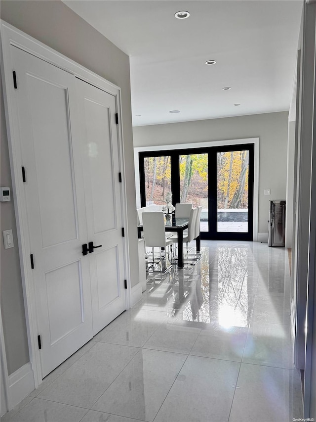 hallway featuring light tile patterned flooring