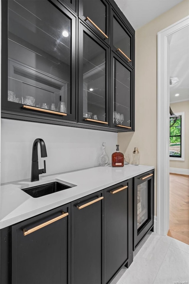 bar with sink and beverage cooler