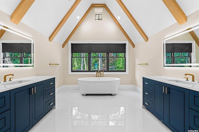 bathroom featuring lofted ceiling with beams, a tub, and vanity