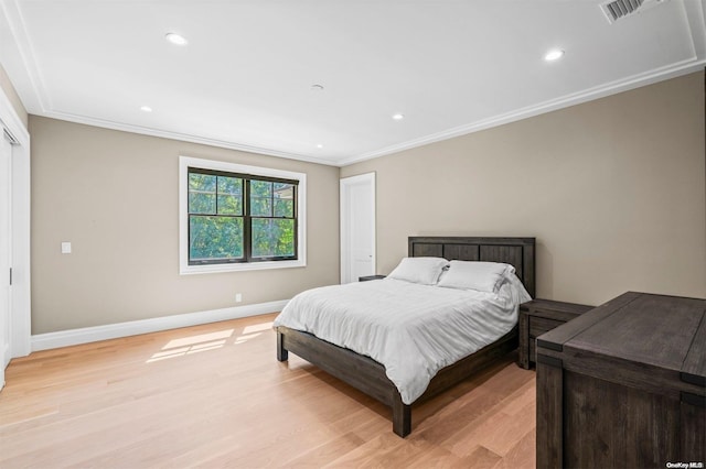 bedroom featuring light hardwood / wood-style flooring and ornamental molding