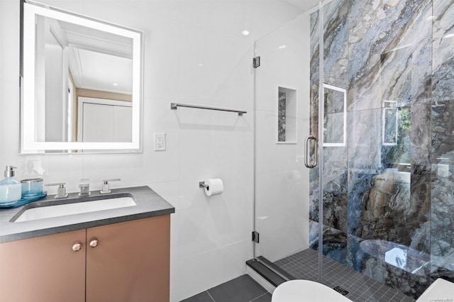 bathroom with vanity, a shower with shower door, tile walls, and toilet