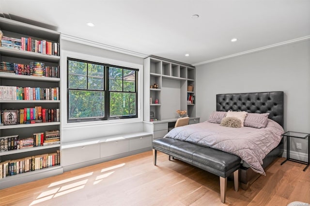 bedroom with light hardwood / wood-style floors and crown molding