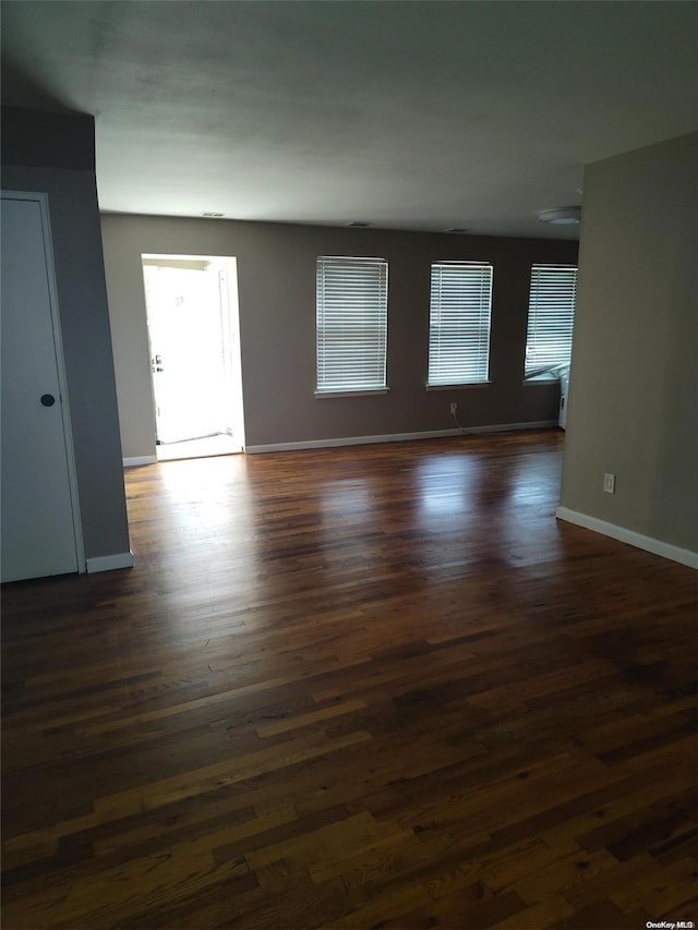 empty room with dark wood-type flooring