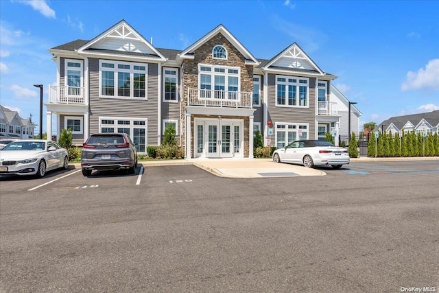 view of property featuring french doors and a balcony