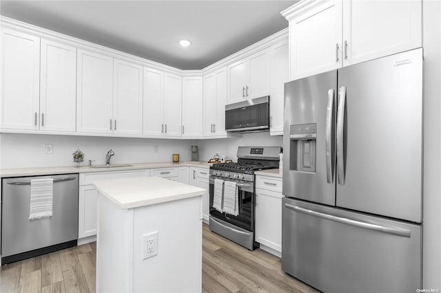 kitchen featuring white cabinetry, sink, appliances with stainless steel finishes, and light hardwood / wood-style flooring