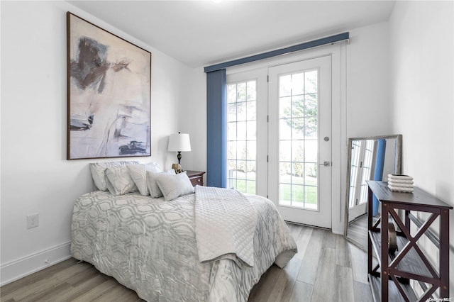 bedroom featuring hardwood / wood-style floors and access to outside