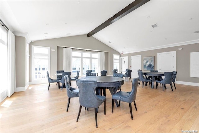 dining room featuring vaulted ceiling with beams, light wood-type flooring, and crown molding