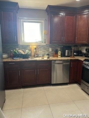 kitchen with decorative backsplash, light tile patterned floors, and stainless steel appliances