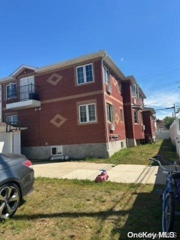 view of side of property with a yard