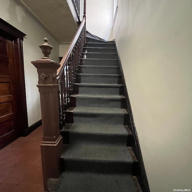 stairway featuring tile patterned flooring