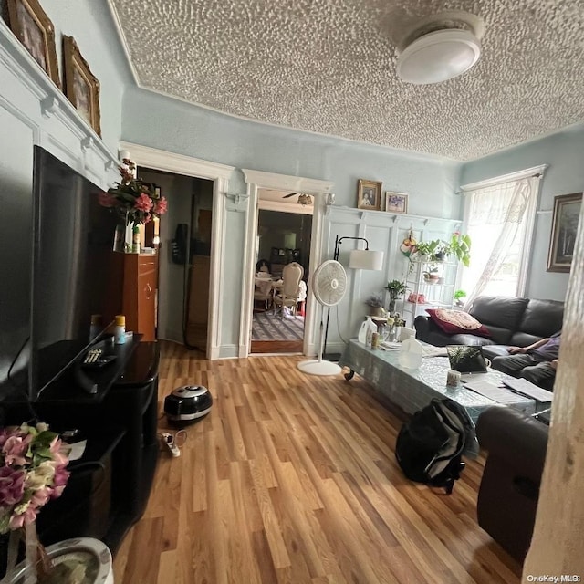 misc room featuring wood-type flooring and a textured ceiling