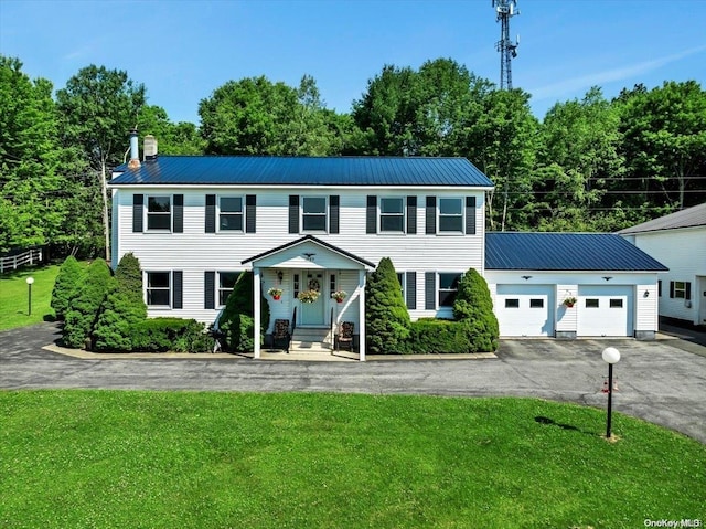 765 Sheep Pen Rd, Call Listing Agent, NY 13849 - colonial house with asphalt driveway, a front lawn, an attached garage, and metal roof