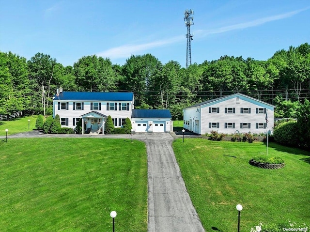 view of front of property with an outbuilding, a front yard, and a garage