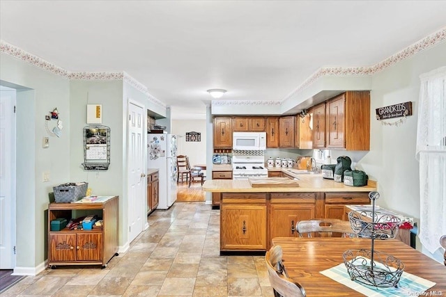 765 Sheep Pen Rd, Call Listing Agent, NY 13849 - kitchen with white appliances, a peninsula, light countertops, brown cabinets, and baseboards