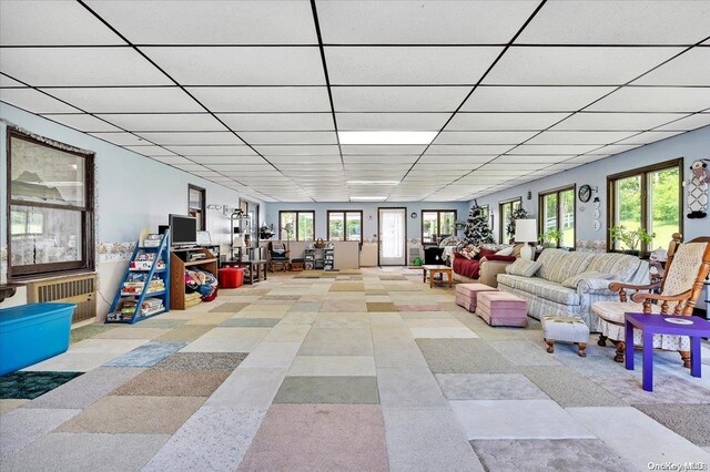 game room featuring a paneled ceiling and a wealth of natural light