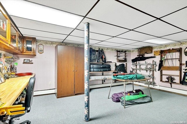 game room with carpet flooring, a drop ceiling, and a baseboard heating unit