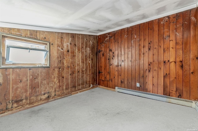 unfurnished room featuring light carpet, baseboard heating, and wooden walls