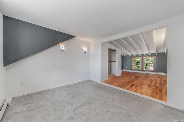 interior space with hardwood / wood-style floors, lofted ceiling with beams, and baseboard heating