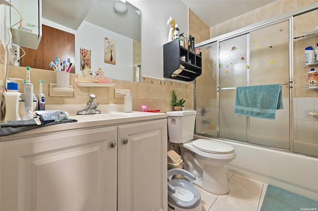 full bathroom featuring tile patterned flooring, enclosed tub / shower combo, decorative backsplash, vanity, and tile walls